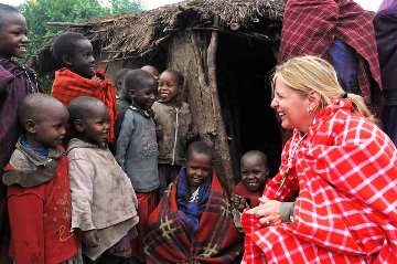A picture of Suzette Munson ministering to 
smiling black children in Rwanda.