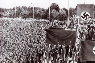A photograph ofAdolph Hitler addressing a huge throng of people.
